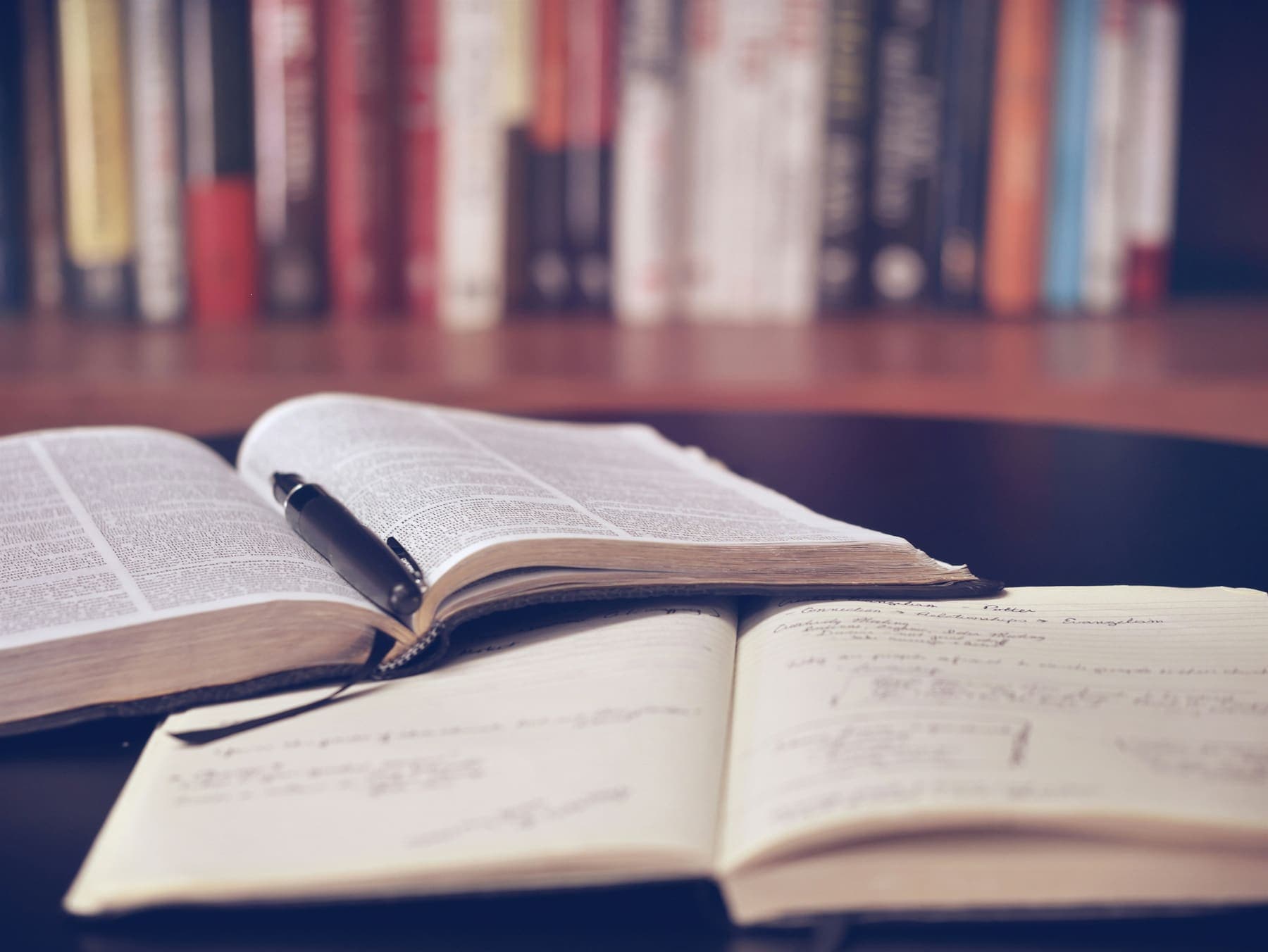 An open notebook and pen on a desk
