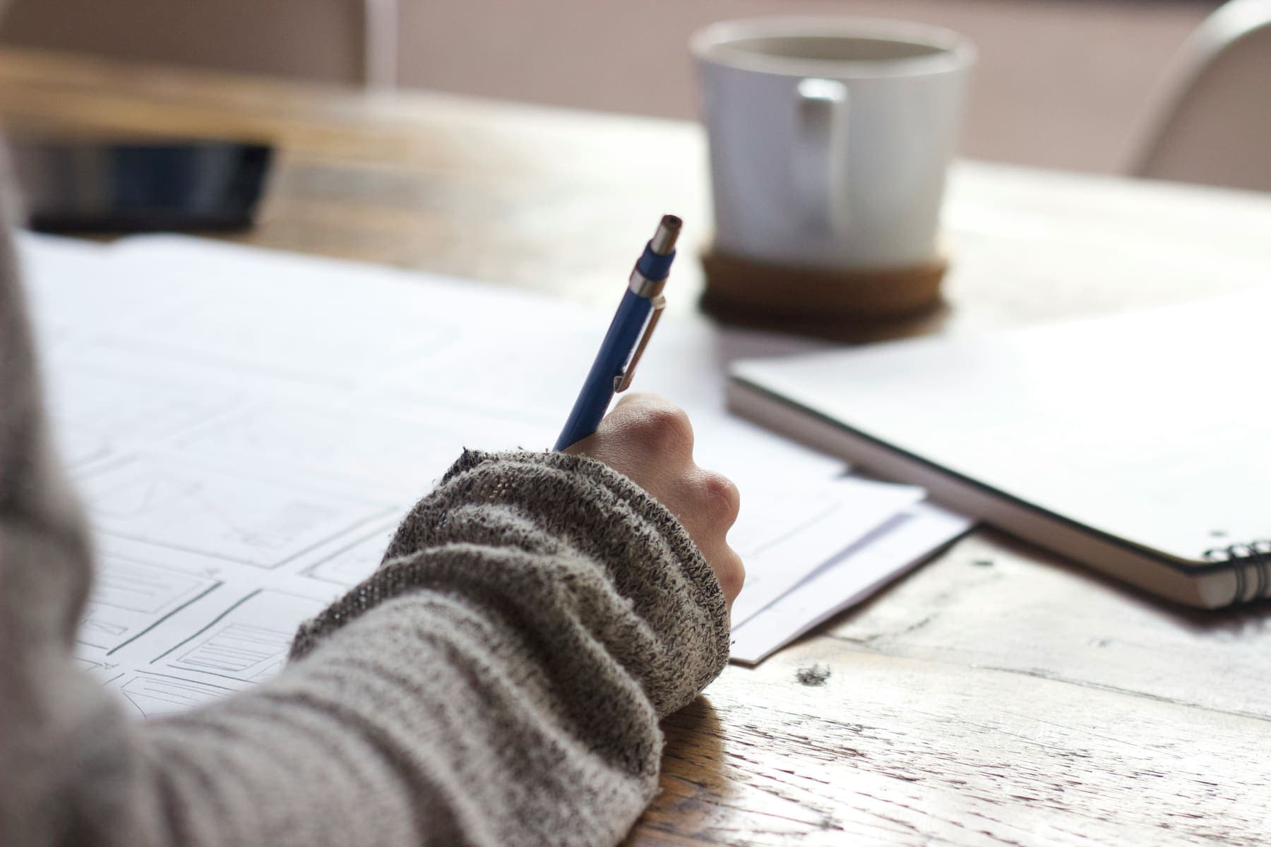 A student writing out an answer by hand